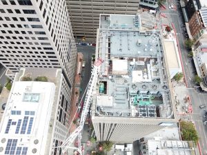 A building rooftop with ongoing work for a standby generator upgrade project by Ryan Wilks